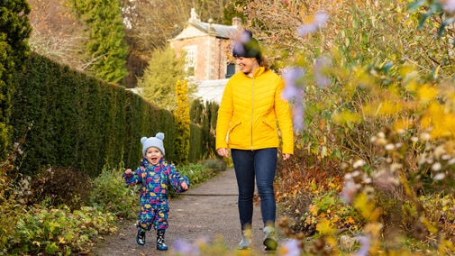 Family visitors in the garden in autumn at Wallington, Northumberland